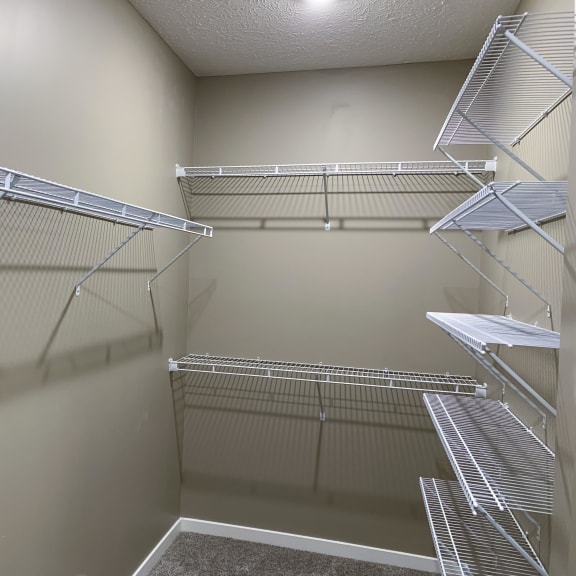 Thumbnail 14 of 15 Walk in closet with plenty of shelving and hanging space