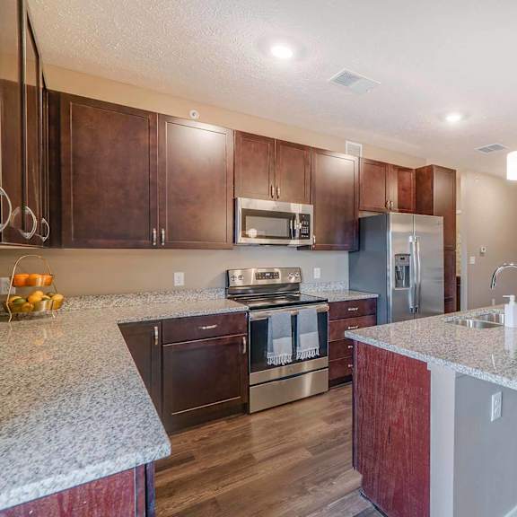 Thumbnail 6 of 15 a kitchen with granite counter tops and stainless steel appliances