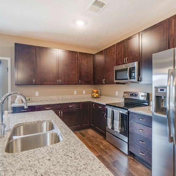 Thumbnail 4 of 15 Spacious kitchens with granite countertops at The Flats at Shadow Creek new luxury apartments in east Lincoln NE 68520