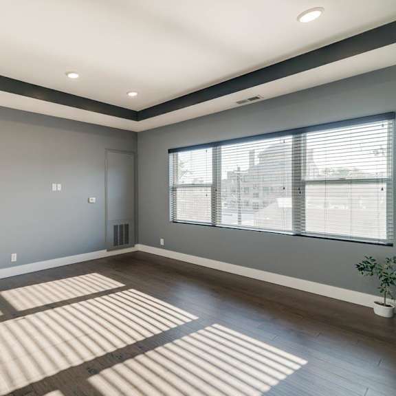 Thumbnail 7 of 16 Living room with wide window and dark brown wood floors