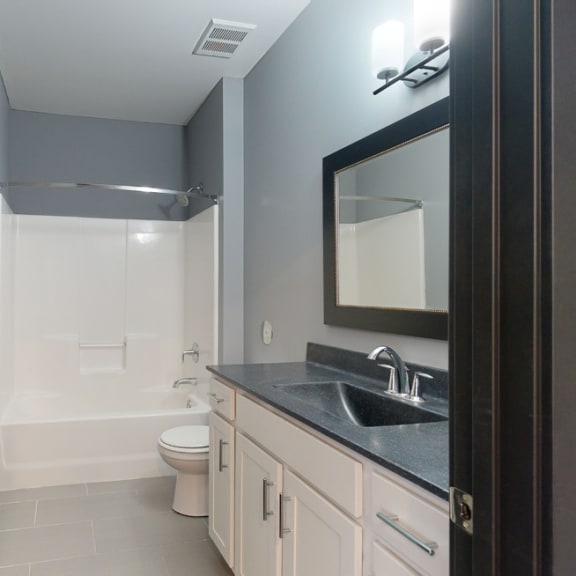 Thumbnail 12 of 14 a bathroom with a toilet sink and bathtub