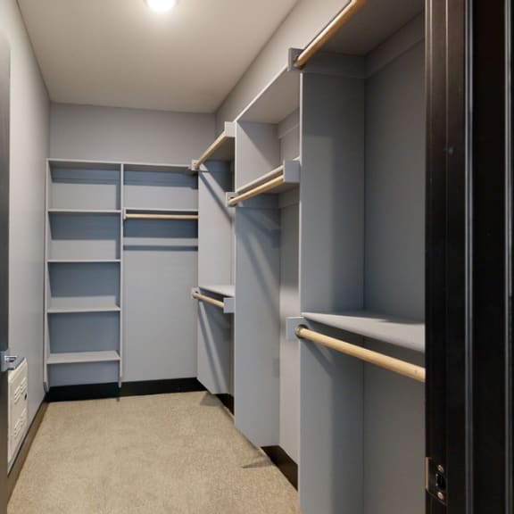 Thumbnail 9 of 14 a walk in closet with gray walls and shelves