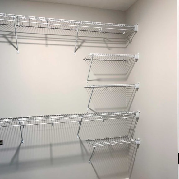 Thumbnail 13 of 20 a walk in closet with extra shelving for storage