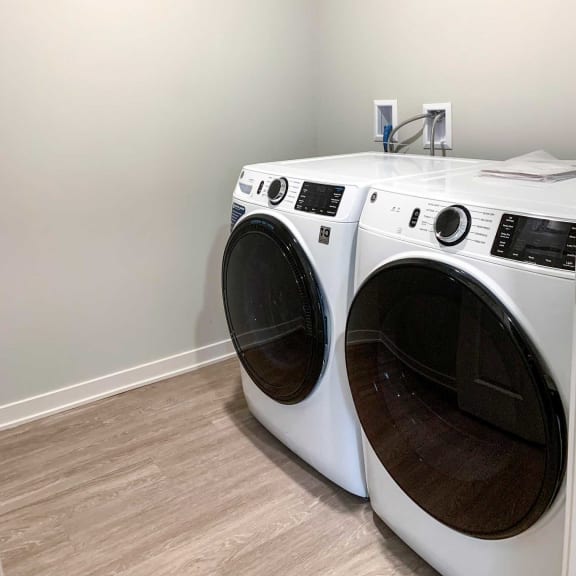 Thumbnail 20 of 20 a washer and dryer in a laundry room with a wooden floor