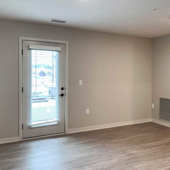 Thumbnail 7 of 20 a living room with wooden flooring and a patio door