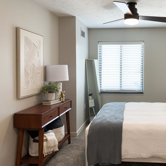 Thumbnail 7 of 24 a bedroom with a ceiling fan and a window