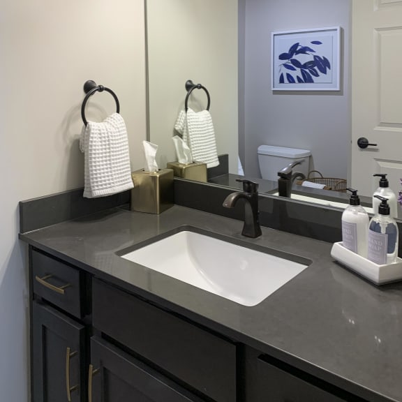 Thumbnail 10 of 24 a bathroom with a sink and a mirror