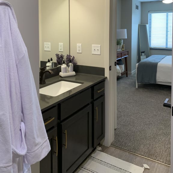 Thumbnail 11 of 24 a bathroom with a sink and a mirror