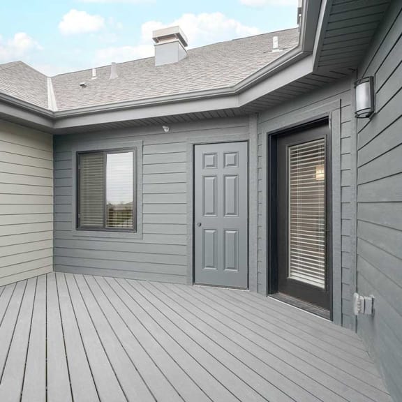 Thumbnail 20 of 29 the door to the balcony with a door to the mechanical room, external lighting, and electrical outlet