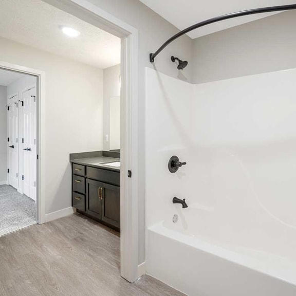 Thumbnail 28 of 29 a bathroom with a tub and shower and a door for privacy from the sink