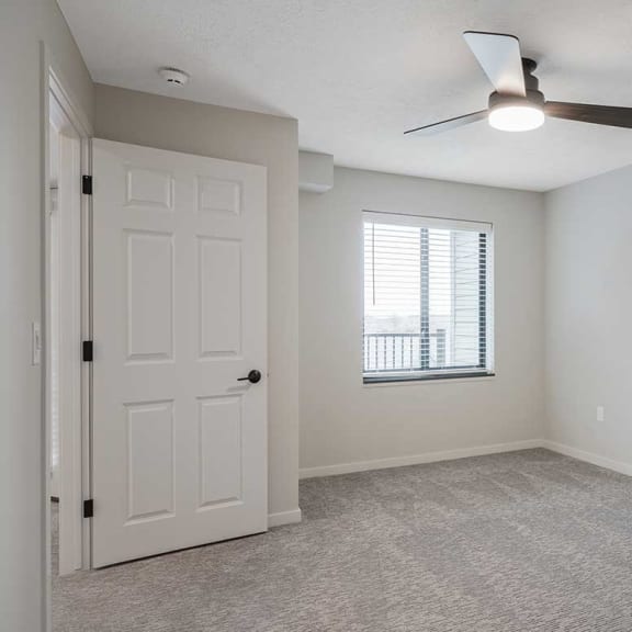 Thumbnail 22 of 29 a bedroom with a window and a ceiling fan