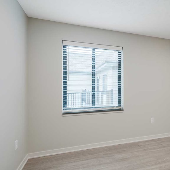Thumbnail 14 of 29 a dining room with hardwood floors and a window