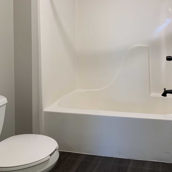 Thumbnail 15 of 15 a white bathroom with a shower and tub combo