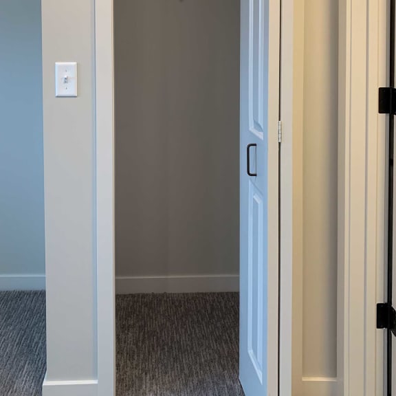 Thumbnail 10 of 15 a hall closet with an upper shelf