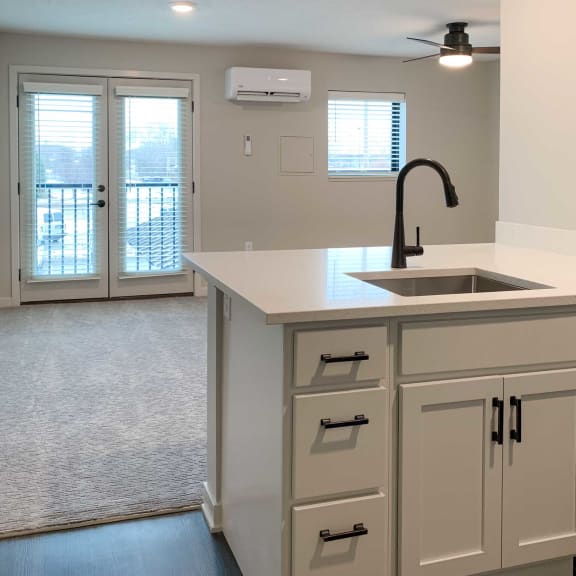 Thumbnail 5 of 15 a kitchen with white cabinets  granite countertops and a stainless steel dishwasher