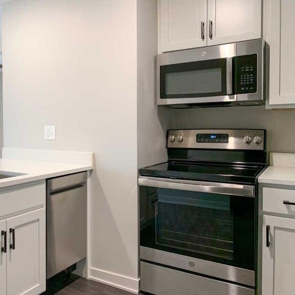Thumbnail 4 of 15 a kitchen with a stainless steel dishwasher microwave and stove