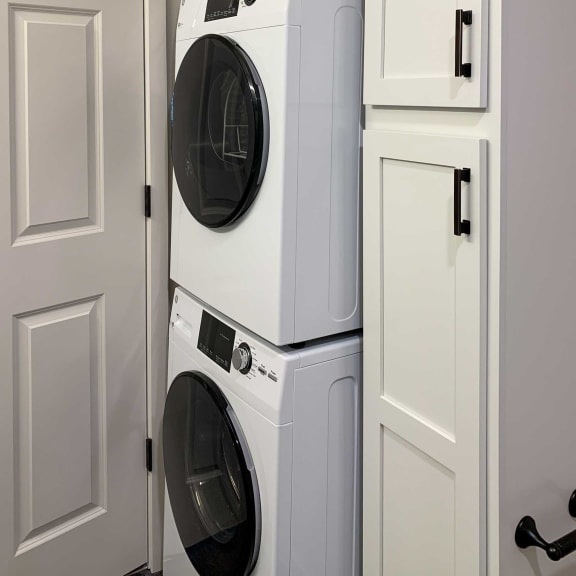 Thumbnail 14 of 15 a white washer and dryer in a laundry room with white doors