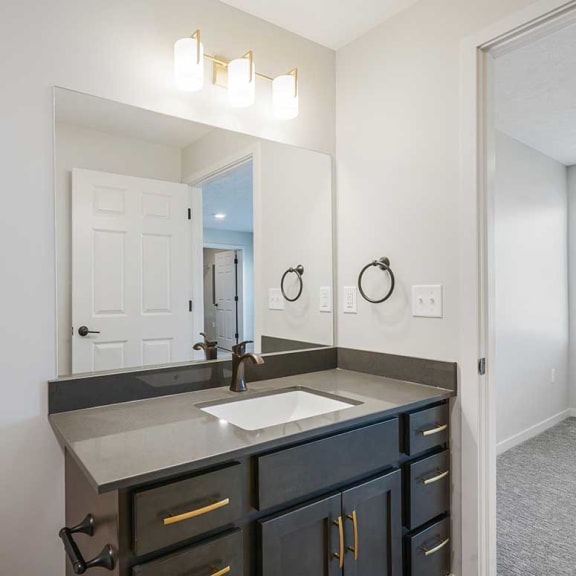 Thumbnail 18 of 19 A bathroom with a vanity sink and a mirror