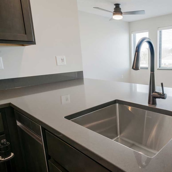 Thumbnail 7 of 19 A stainless steel drop-in sink with a gooseneck faucet