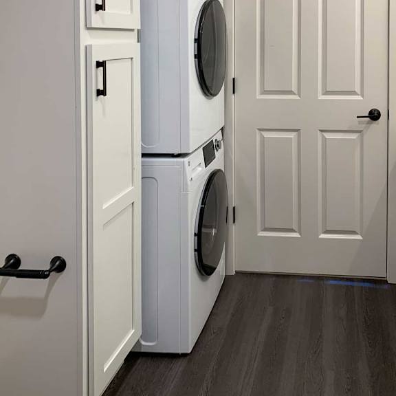 Thumbnail 25 of 25 a bathroom with a linen storage cabnet and a stackable washer and dryer