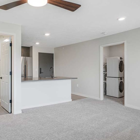 Thumbnail 13 of 17 a main room with doors to the bathroom and closet on opposite sides of the kitchen space
