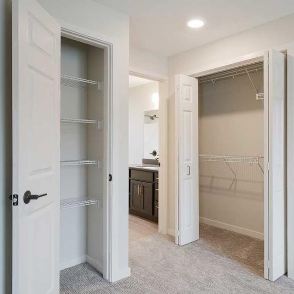 Thumbnail 27 of 30 A double door closet and linen closet in the primary bedroom