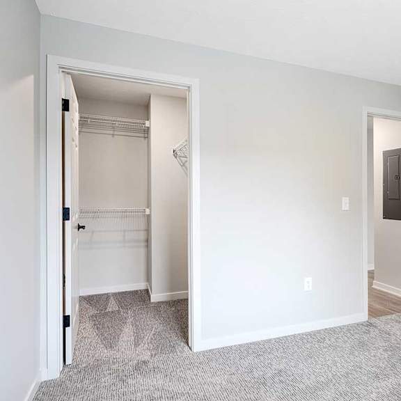 Thumbnail 21 of 30 The second bedroom in the Dove floorplan featuring the walk-in closet with built-in shelving