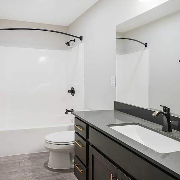 Thumbnail 18 of 30 The hallway bathroom featuring a tub shower with modern dark finishes