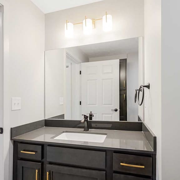 Thumbnail 16 of 25 a bathroom with a vanity sink and a mirror