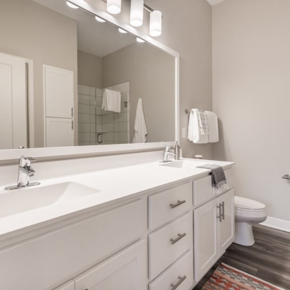 Thumbnail 16 of 18 Bathroom with white cabinets and white, cultured-marble countertops and double sinks