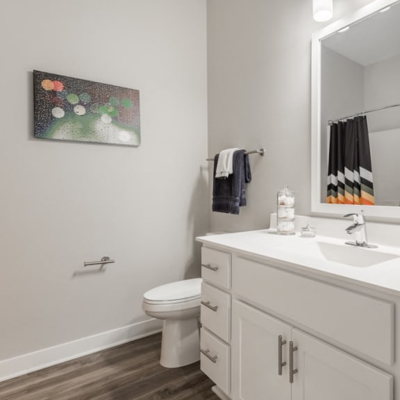 Thumbnail 12 of 18 Bathroom with white cabinets and white, cultured-marble countertops