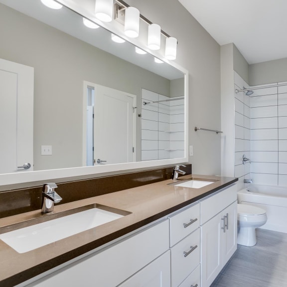 Thumbnail 14 of 18 You'll love the bathroom with dual vanities and custom-tiled tub and shower