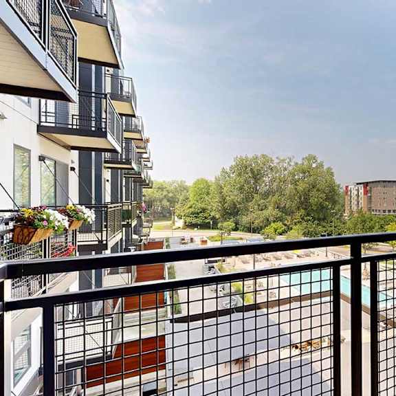 Thumbnail 11 of 25 A balcony with a metal railing and a view of the courtyard.