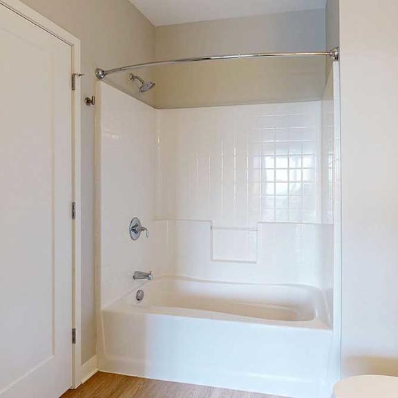 Thumbnail 24 of 27 A bathroom with a tub shower.
