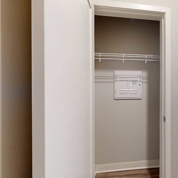 Thumbnail 22 of 29 A coat closet with a built-in wire shelf.