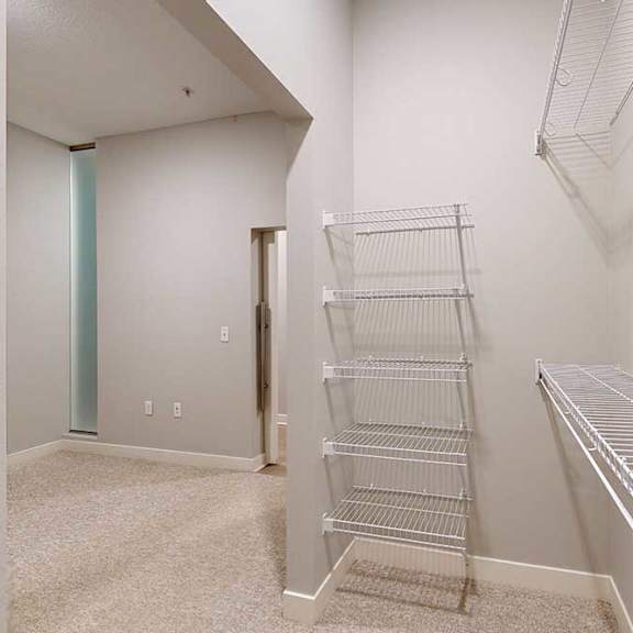 Thumbnail 8 of 21 An oversized walk-in closet with several built-in wire shelves.
