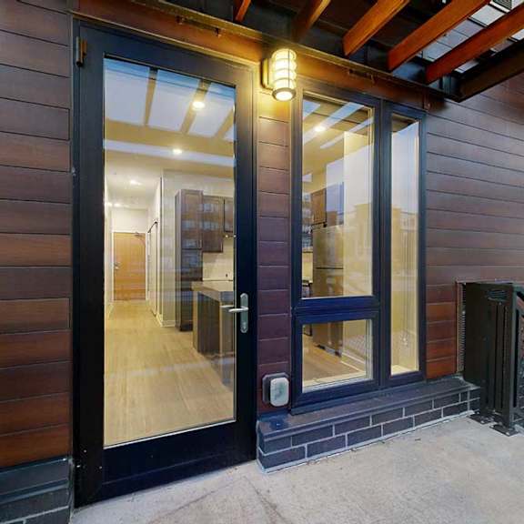 Thumbnail 18 of 21 A patio with floor-to-ceiling windows into the living area.