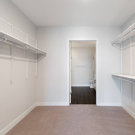 Thumbnail 10 of 15 Large walk in closet with ample shelving and hanging space
