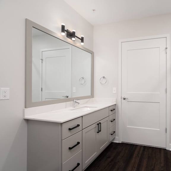 Thumbnail 14 of 15 beautiful white bathroom with grey vanity and large mirror with glass shower doors