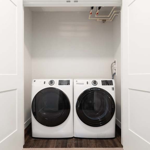 Thumbnail 15 of 15 washer and dryer side by side in laundry closet with doors open