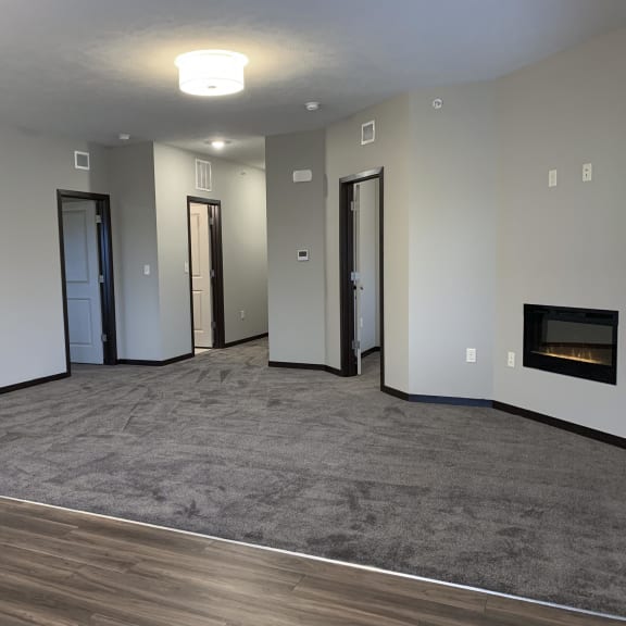 Thumbnail 11 of 23 Carpeted living area with built in electric fire place at the villas at mahoney park