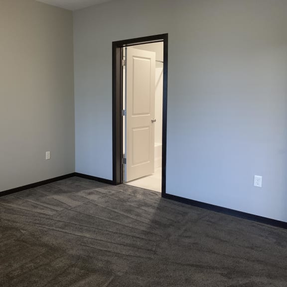 Thumbnail 13 of 23 Large carpeted master bedroom at the villas at mahoney park