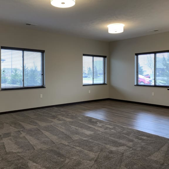 Thumbnail 6 of 23 Living and dining area with three windows at the villas at mahoney park
