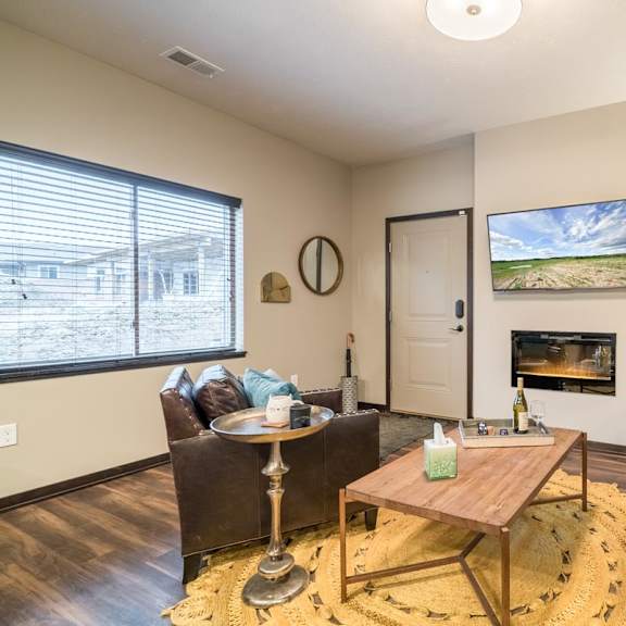 a living room with a fireplace and a painting on the wall.