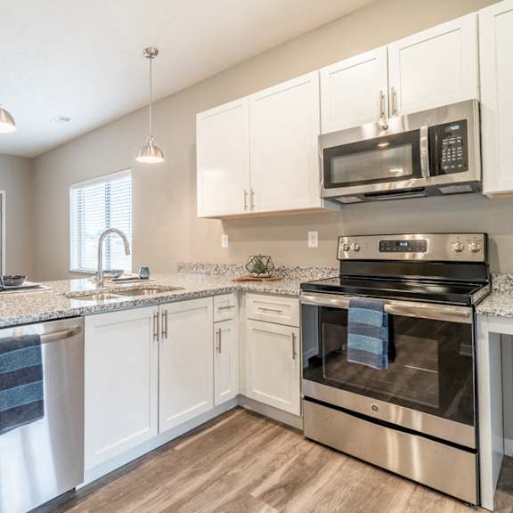 Thumbnail 7 of 14 Kitchen with white cabinets and stainless steel appliances