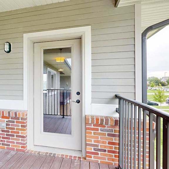 Thumbnail 14 of 25 A balcony with a windowed door leading into the living room.