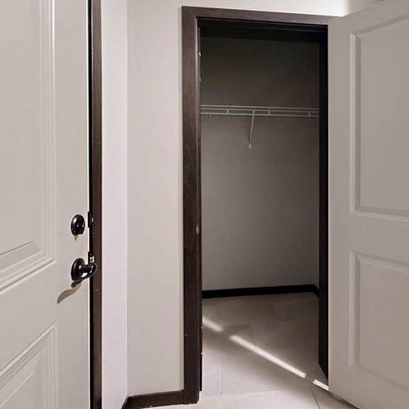 Thumbnail 4 of 25 A coat closet in the main entryway with a built-in wire shelf.