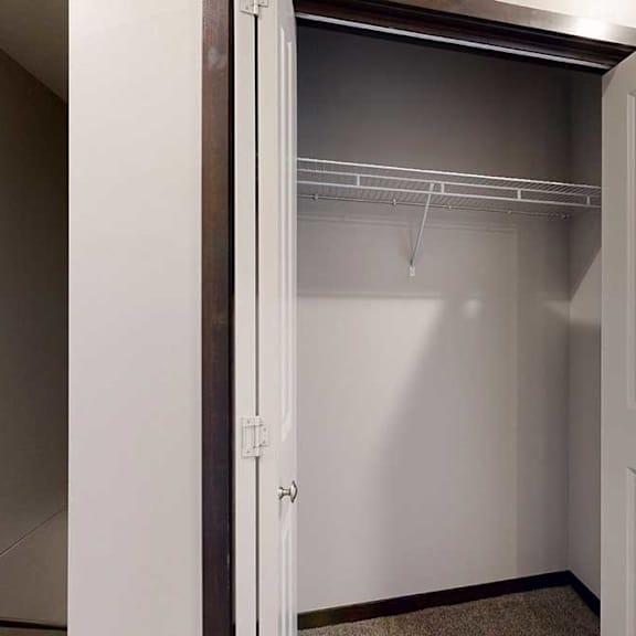 Thumbnail 6 of 25 A double-door closet with a built-in wire shelf, at the top of the stairway.