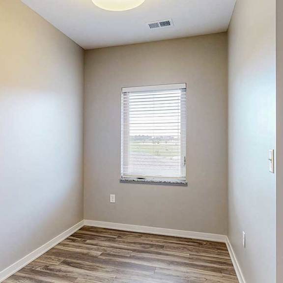 Thumbnail 19 of 26 A nook area with hardwood-style flooring and a large window.