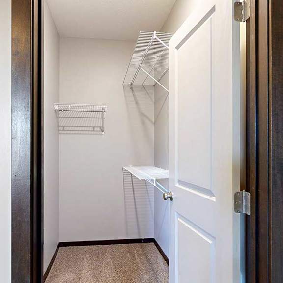 Thumbnail 22 of 24 An oversized walk-in closet with several built-in wire shelves.